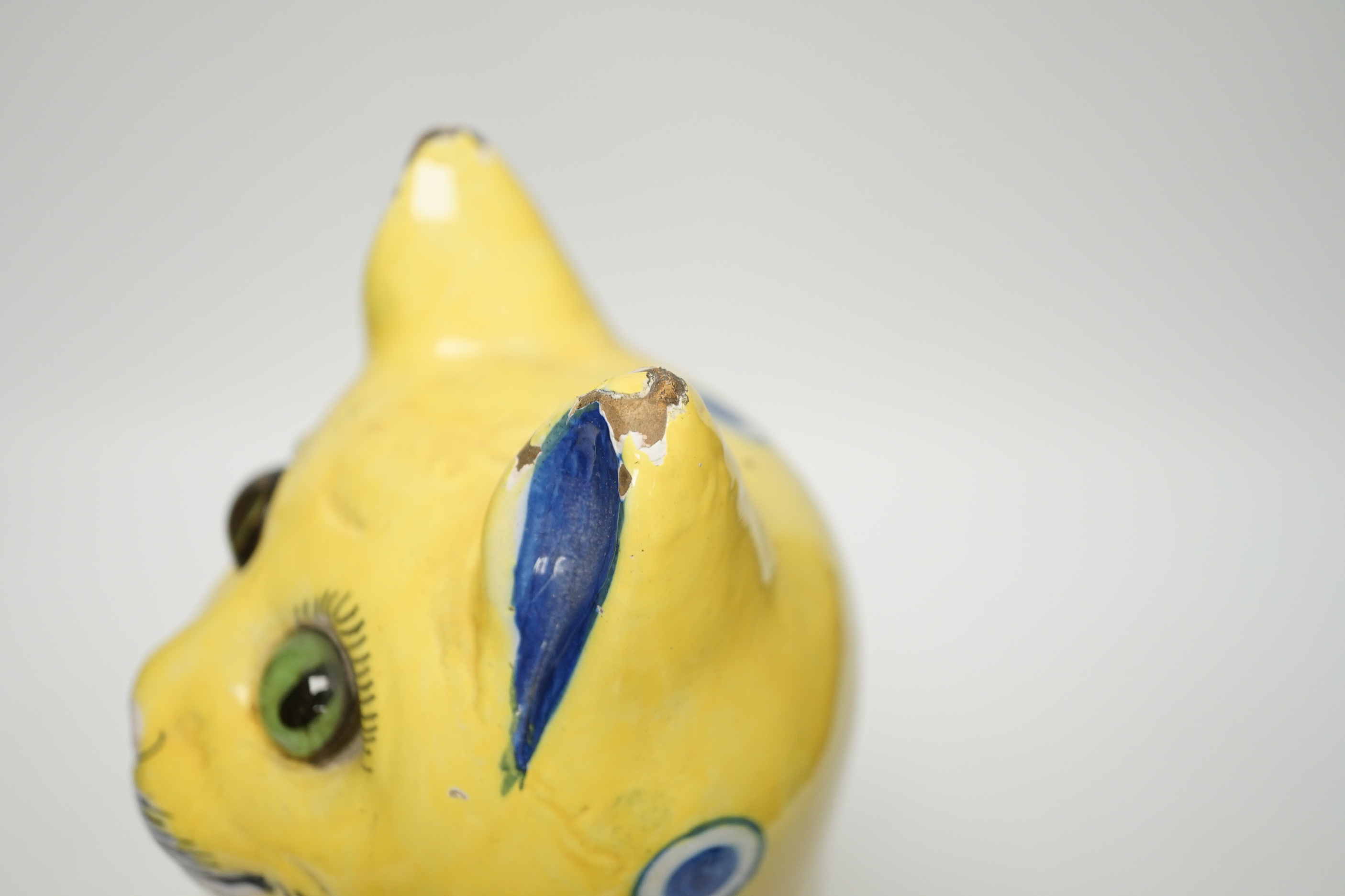 A Gallé yellow glazed model cat with glass eyes, signed E. Gallé, Nancy, 32cm high